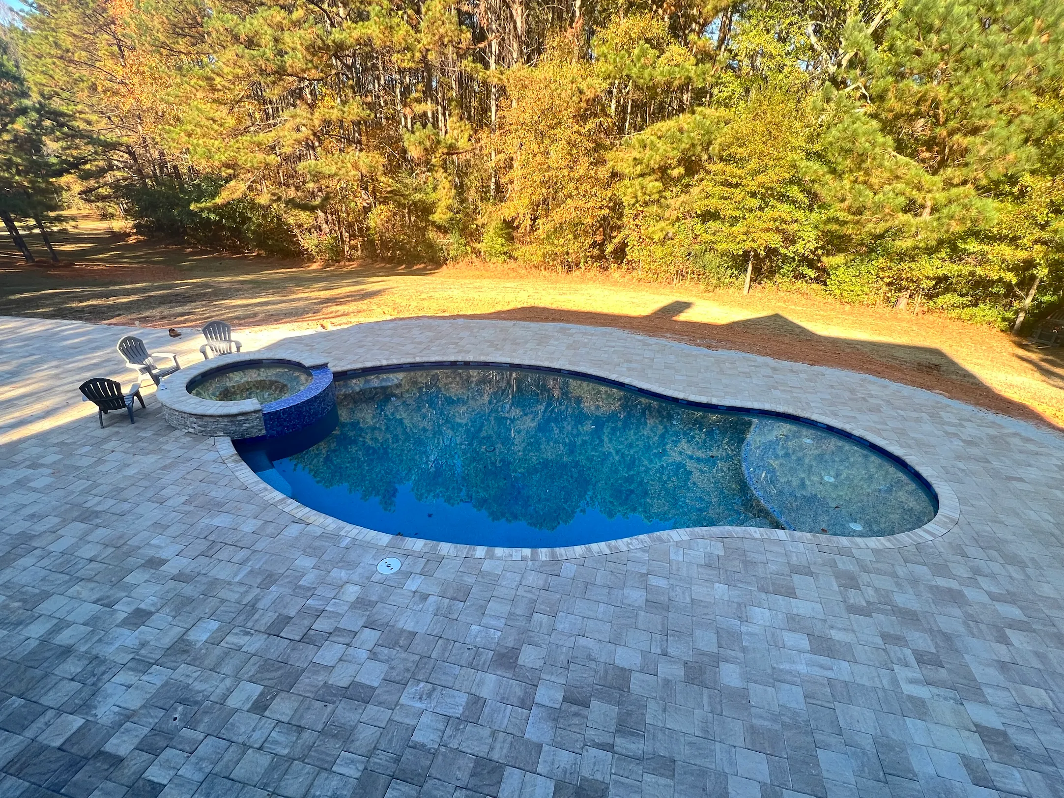 Drone view of a finished RutherfordMade backyard with pool, patio, and landscape