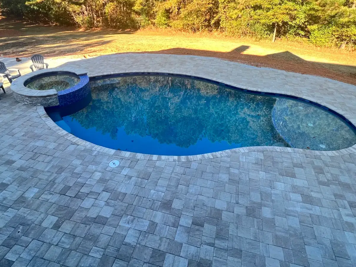 RutherfordMade custom pool and spa with paver patio and backyard lounge area